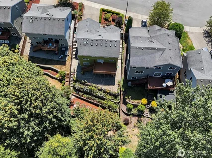 an aerial view of a house with a yard and a fountain