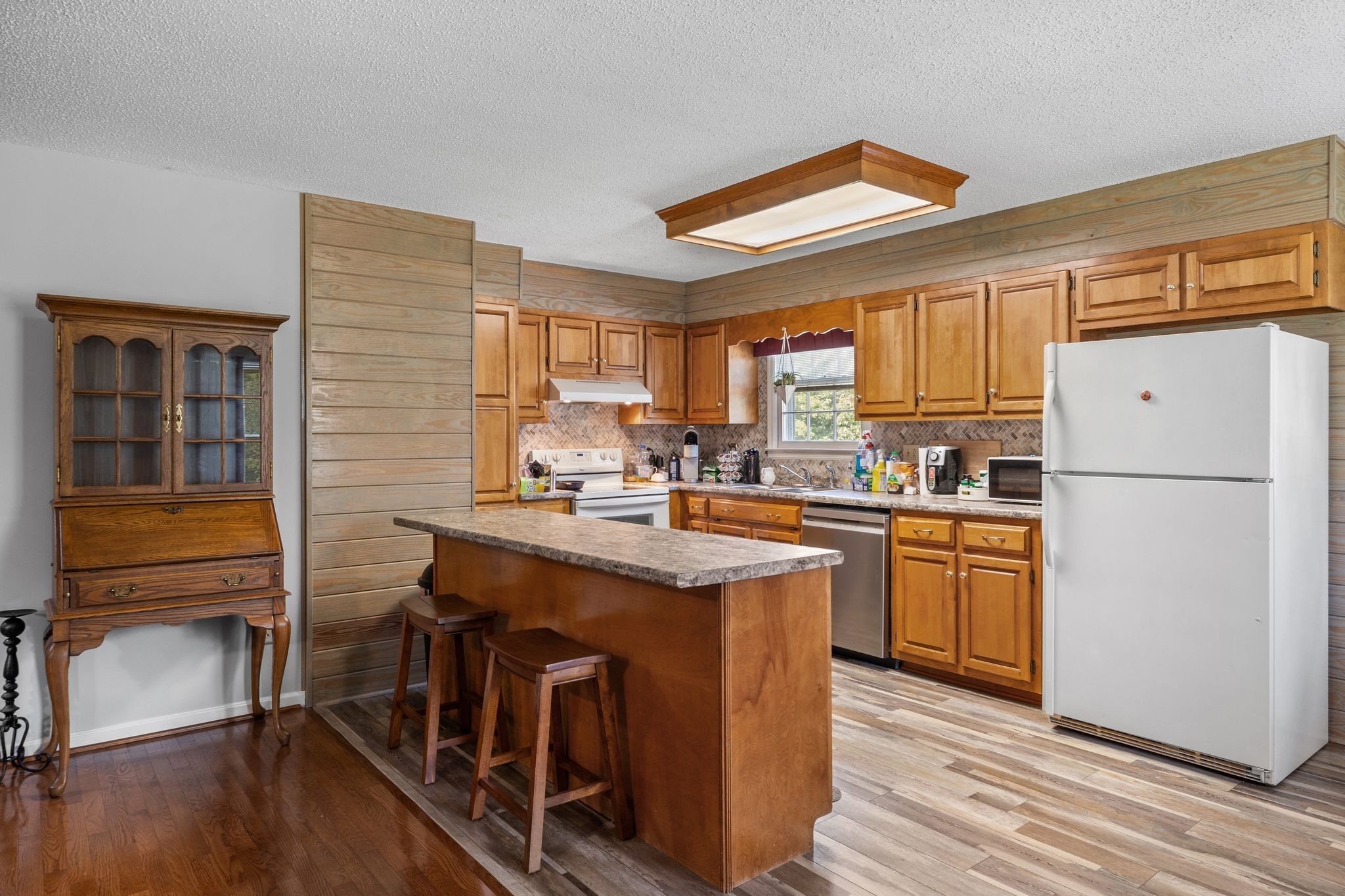 4628 Dugger Road Culleoka, TN 38451 - Photo 19 of 40 a kitchen with stainless steel appliances granite countertop a refrigerator a sink dishwasher a stove with white cabinets and wooden floor