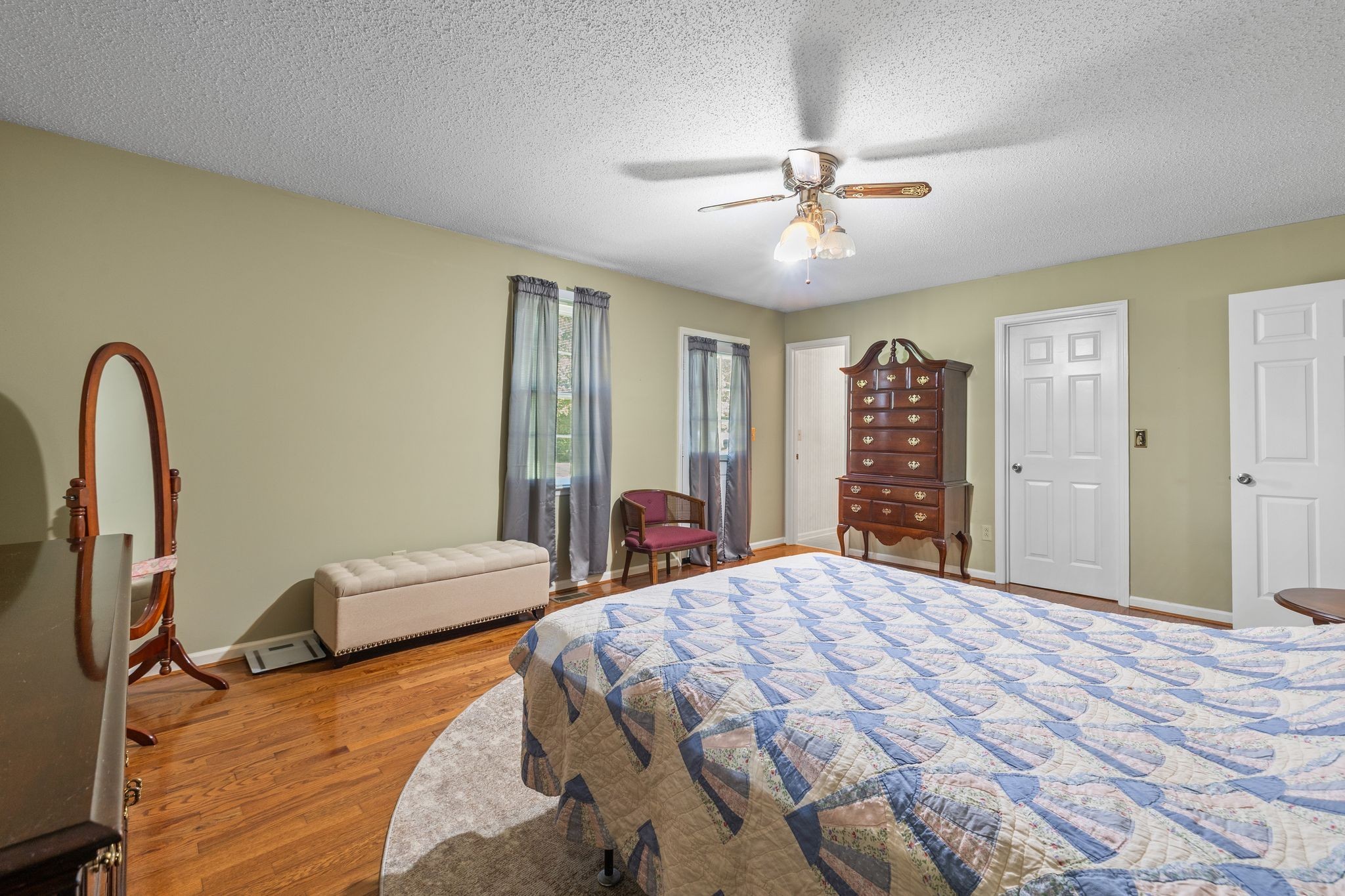 4628 Dugger Road Culleoka, TN 38451 - Photo 24 of 40 a bedroom with a large bed and a chandelier