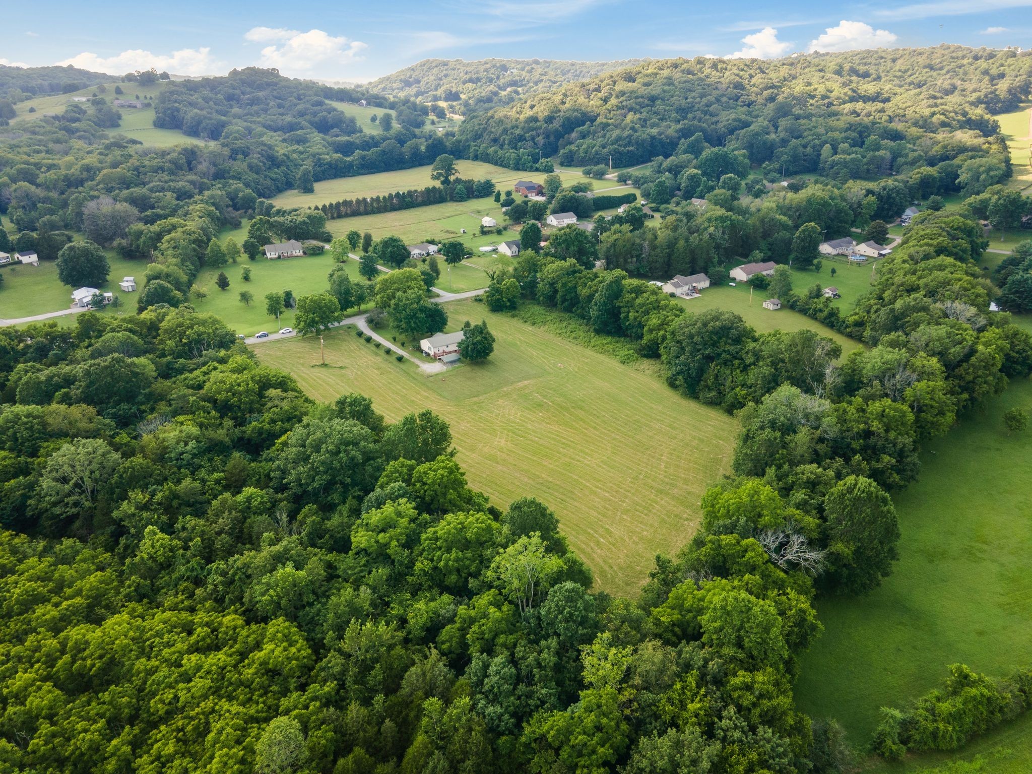 4628 Dugger Road Culleoka, TN 38451 - Photo 37 of 40 an aerial view of green landscape with trees houses and mountain view