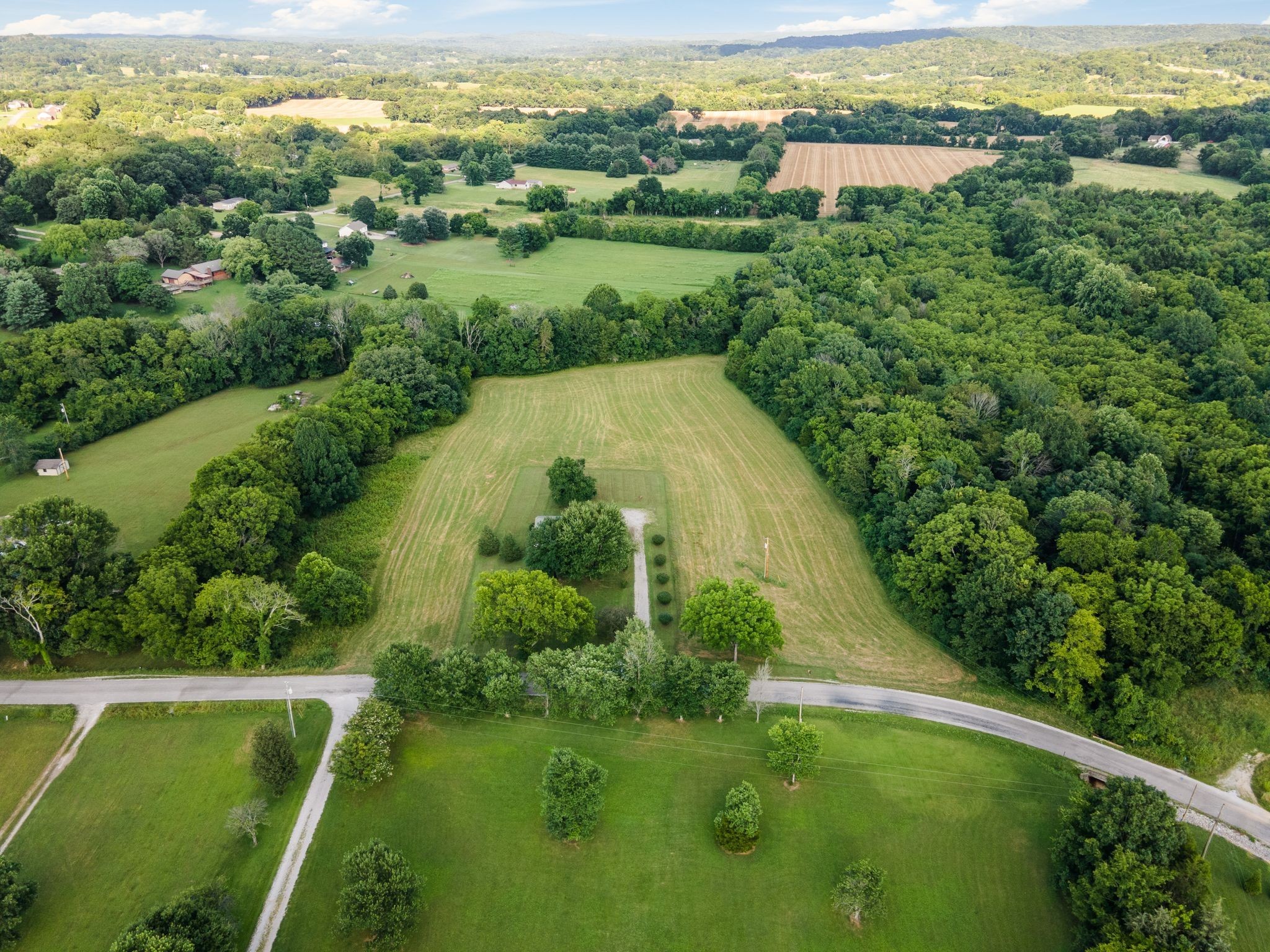 4628 Dugger Road Culleoka, TN 38451 - Photo 4 of 40 an aerial view of green landscape with trees houses and mountain view