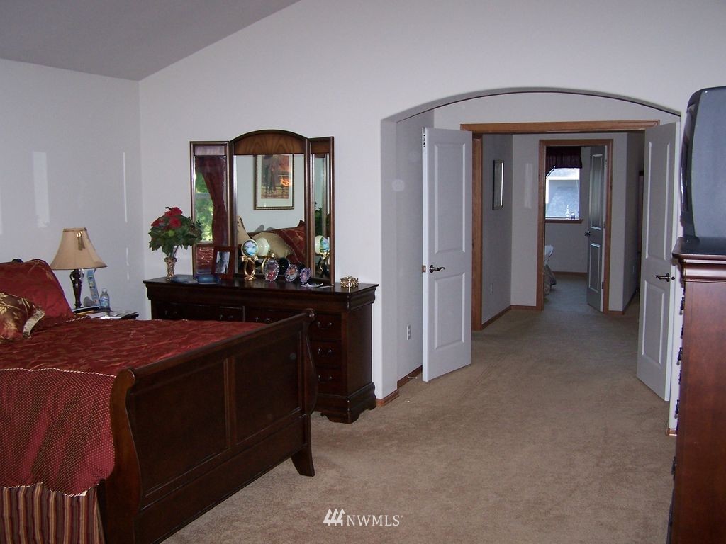 23812 22nd Avenue West Bothell, WA 98021 - Photo 13 of 19 a bedroom with a bed and a mirror on dresser