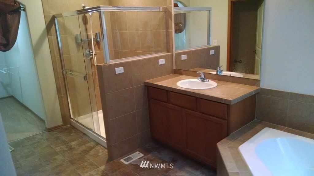 23812 22nd Avenue West Bothell, WA 98021 - Photo 15 of 19 a bathroom with a sink a mirror and shower