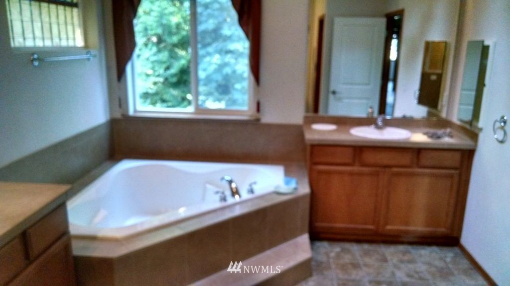 23812 22nd Avenue West Bothell, WA 98021 - Photo 16 of 19 a bathroom with a tub sink and mirror