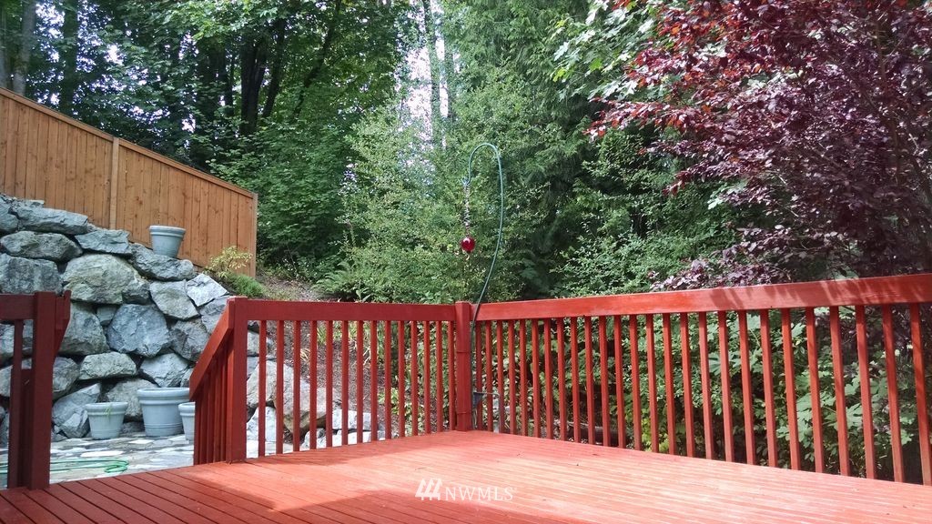 23812 22nd Avenue West Bothell, WA 98021 - Photo 17 of 19 a balcony with wooden floor and yard in the back