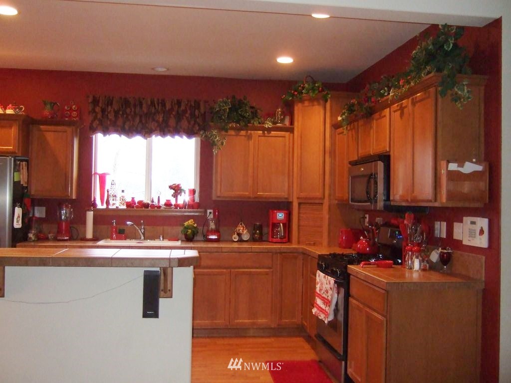 23812 22nd Avenue West Bothell, WA 98021 - Photo 9 of 19 a kitchen with a sink a counter top space and appliances