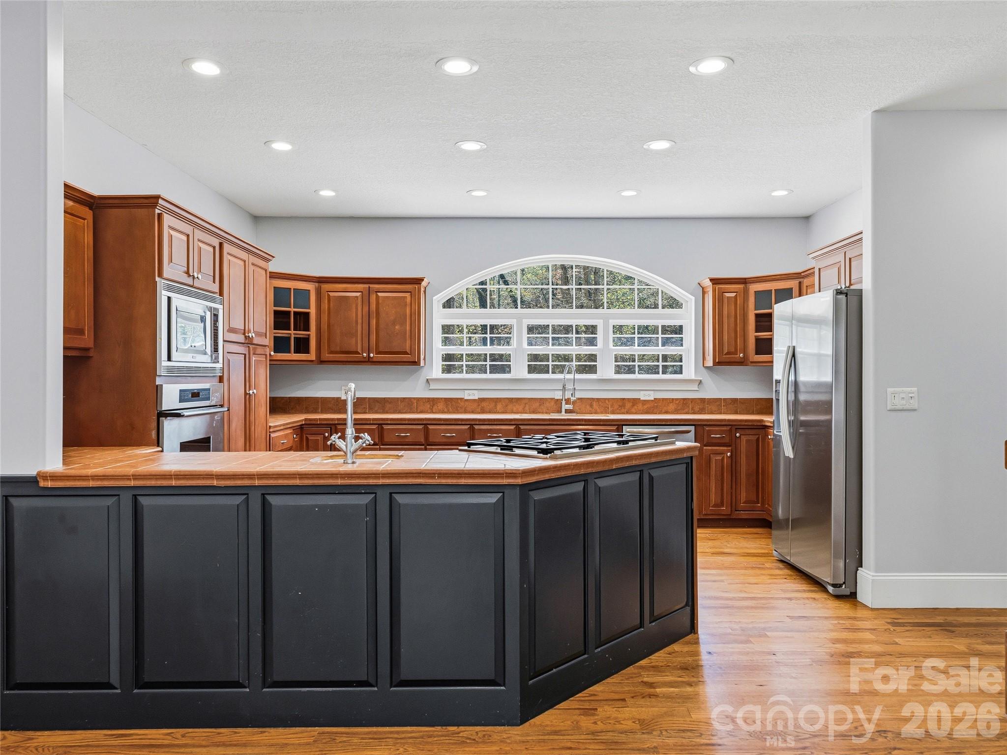 196 Blackbird Lane Tryon, NC 28782 - Photo 14 of 44 a kitchen with stainless steel appliances granite countertop a stove and a refrigerator
