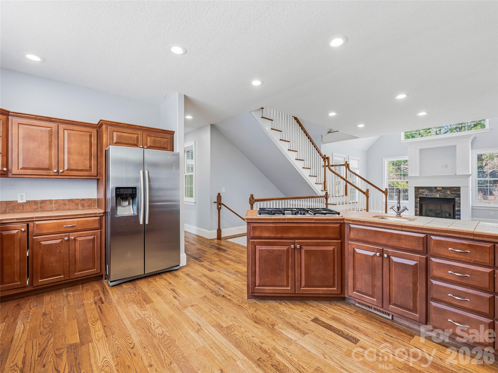 196 Blackbird Lane Tryon, NC 28782 - Photo 16 of 44 a kitchen with stainless steel appliances granite countertop a refrigerator a stove and a sink with wooden cabinets