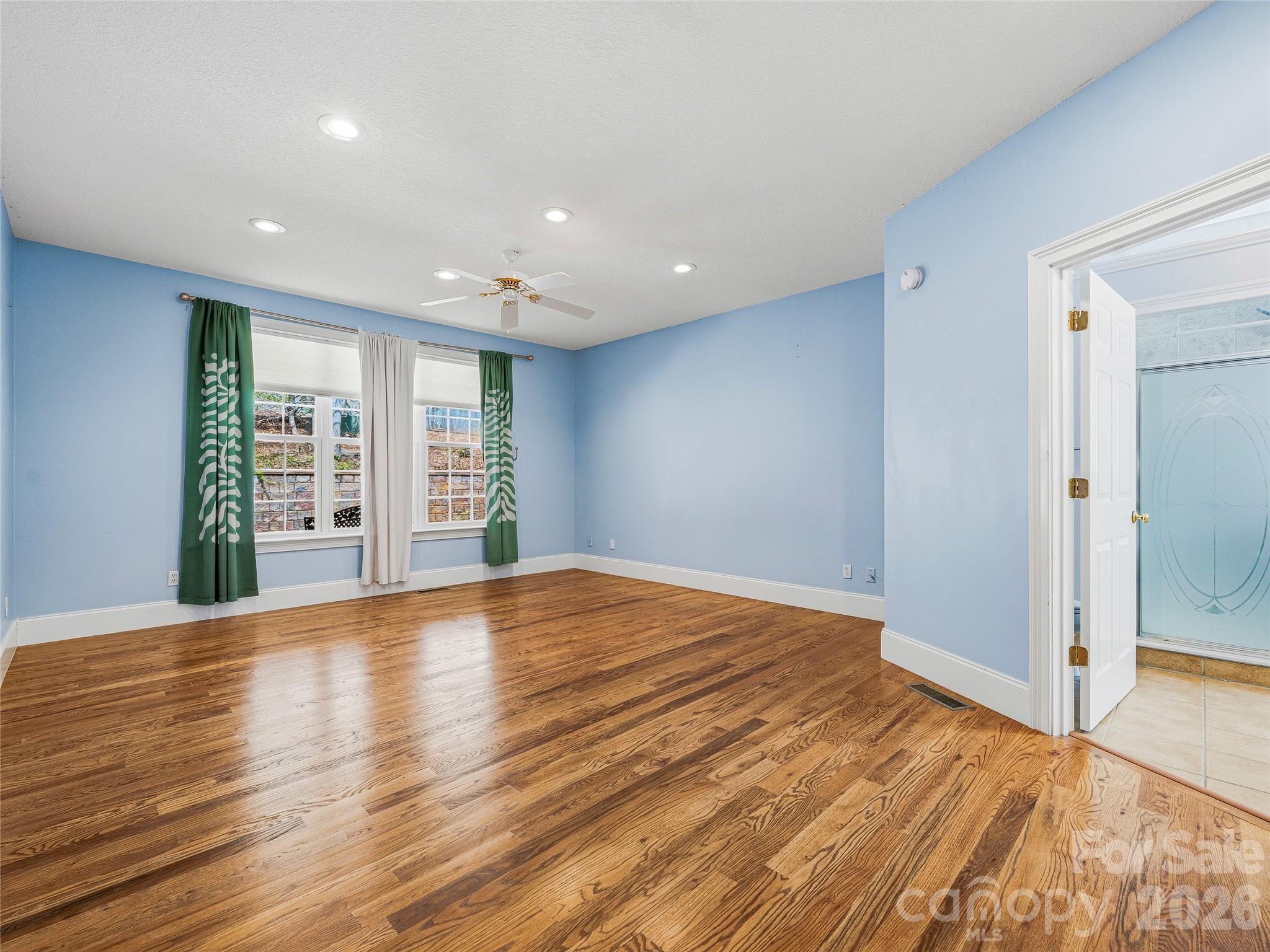 196 Blackbird Lane Tryon, NC 28782 - Photo 22 of 44 a view of an empty room with wooden floor and a window
