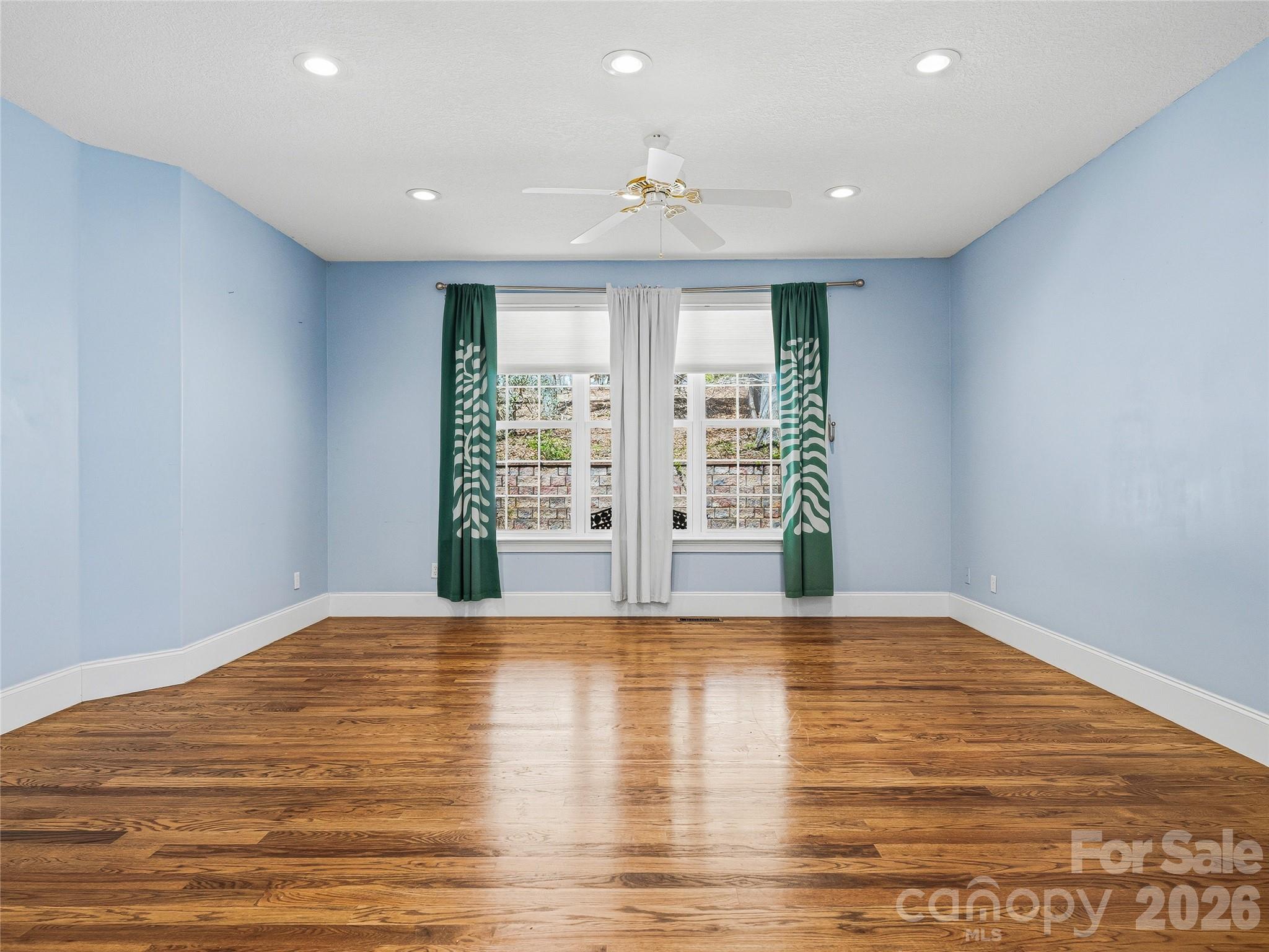 196 Blackbird Lane Tryon, NC 28782 - Photo 23 of 44 a view of an empty room with wooden floor and a window