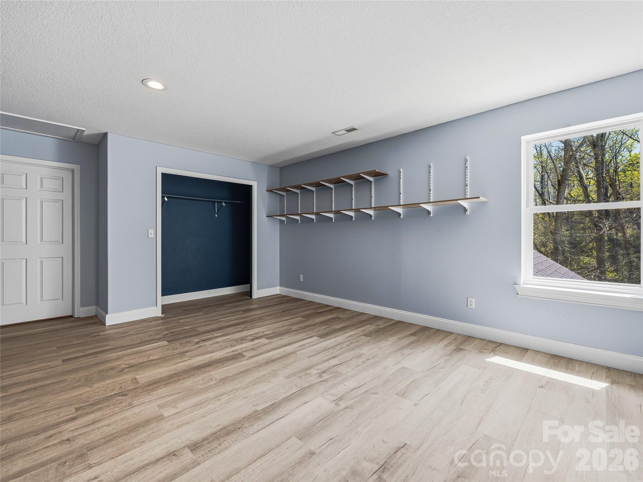 196 Blackbird Lane Tryon, NC 28782 - Photo 32 of 44 a view of empty room with wooden floor and fan
