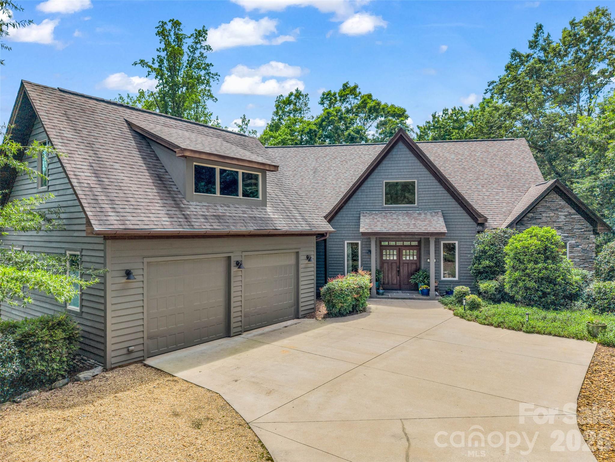 120 Glenn Court Mill Spring, NC 28756 - Photo 4 of 48 a front view of a house with a garden