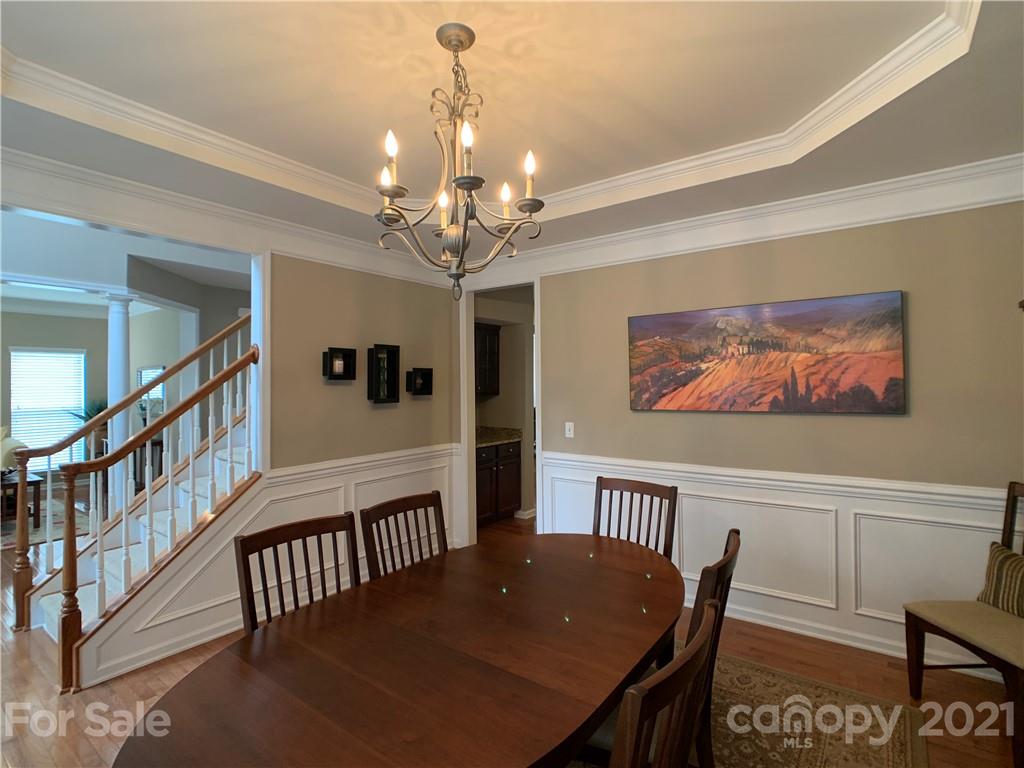 1920 Faison Avenue Fort Mill, SC 29708 - Photo 14 of 47 a view of a dining room with furniture a chandelier and wooden floor