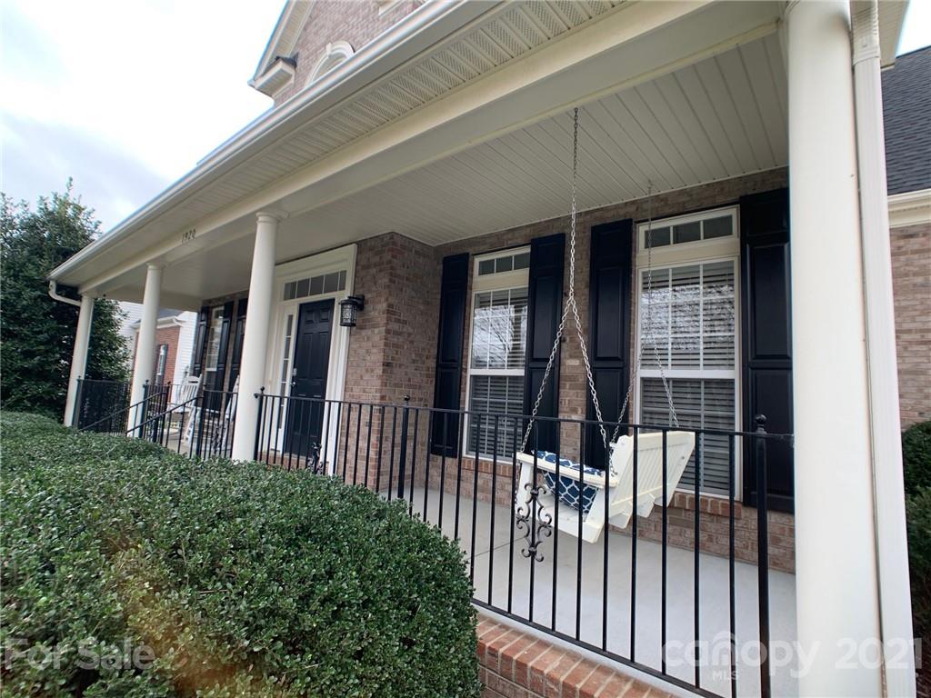 1920 Faison Avenue Fort Mill, SC 29708 - Photo 3 of 47 a view of a brick house with large windows and a table
