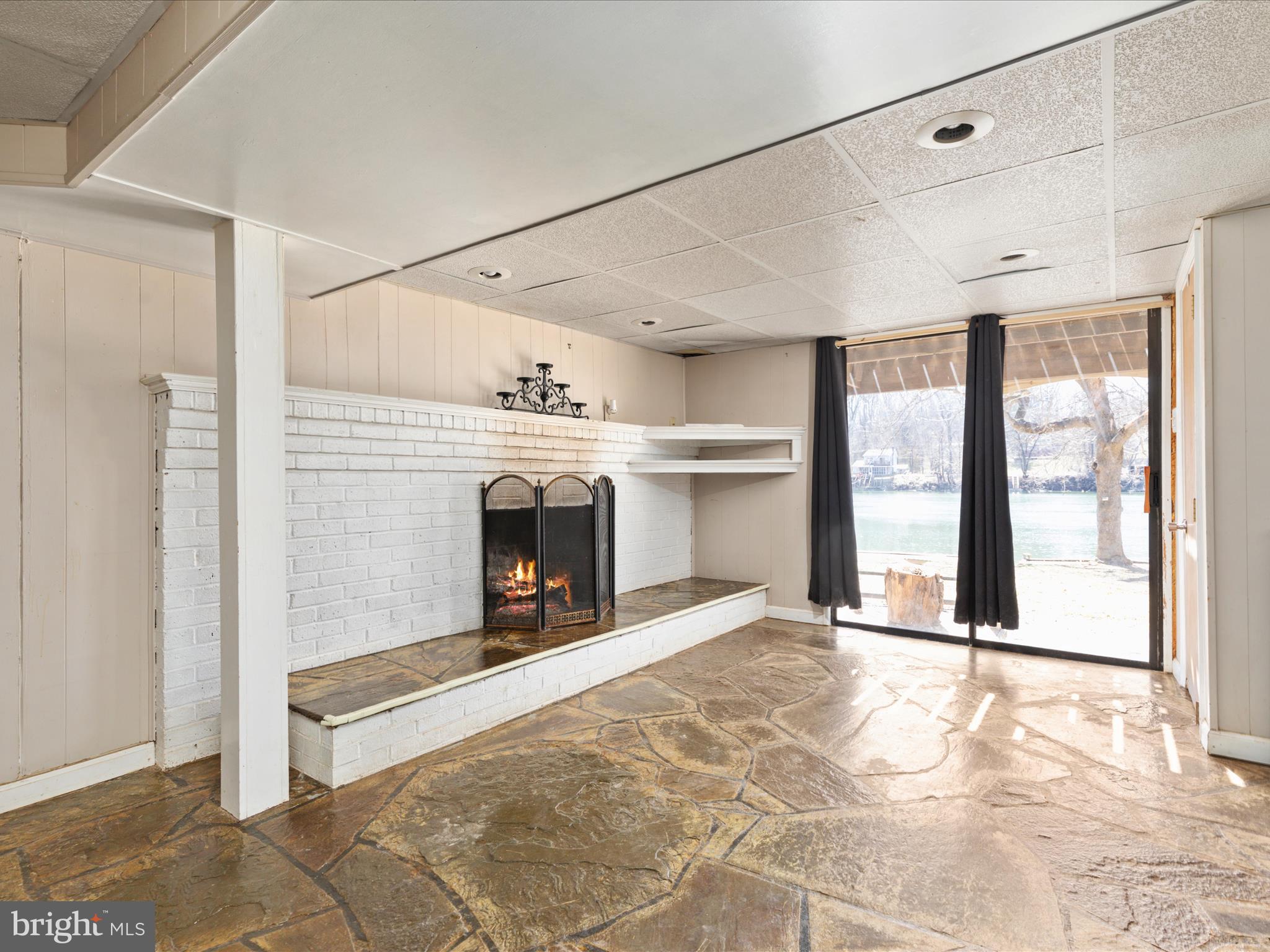 646 Old Dam Road Front Royal, VA 22630 - Photo 26 of 88 a view of an empty room with a fireplace and a window