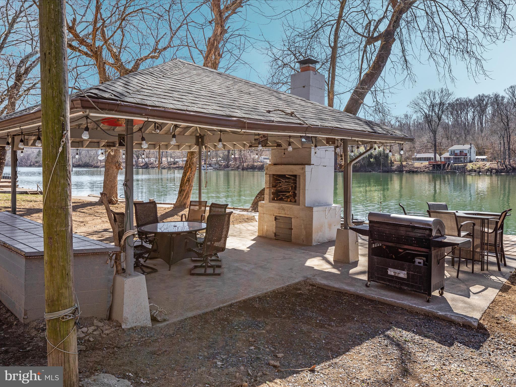 646 Old Dam Road Front Royal, VA 22630 - Photo 36 of 88 a view of a patio with a table chairs and a backyard