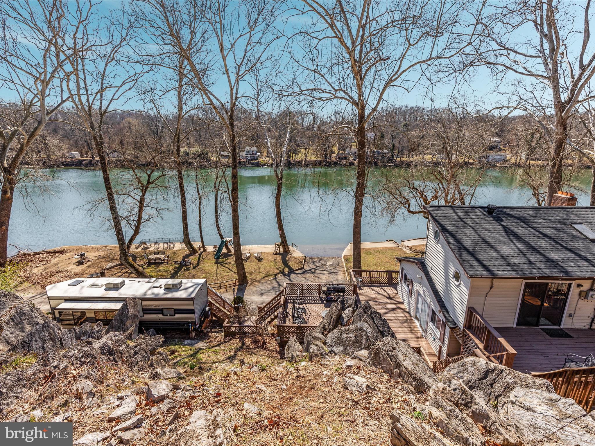 646 Old Dam Road Front Royal, VA 22630 - Photo 45 of 88 a view of a lake with couches and wooden fence