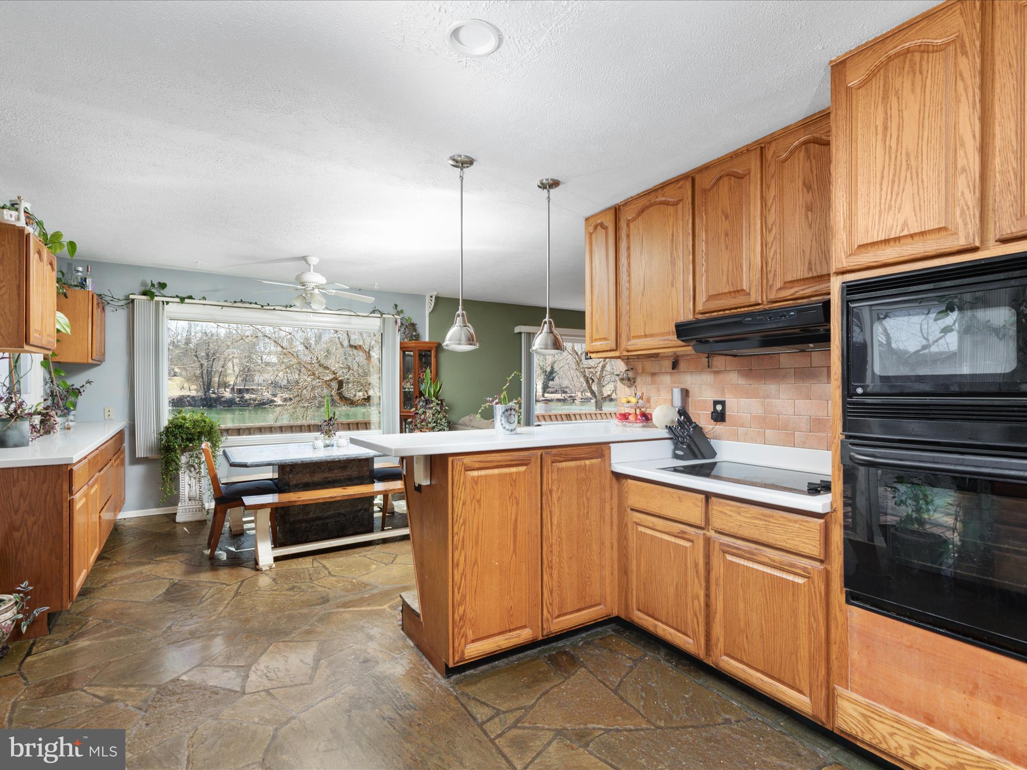 646 Old Dam Road Front Royal, VA 22630 - Photo 5 of 88 a kitchen with stainless steel appliances granite countertop a stove top oven a sink dishwasher and cabinets with wooden floor