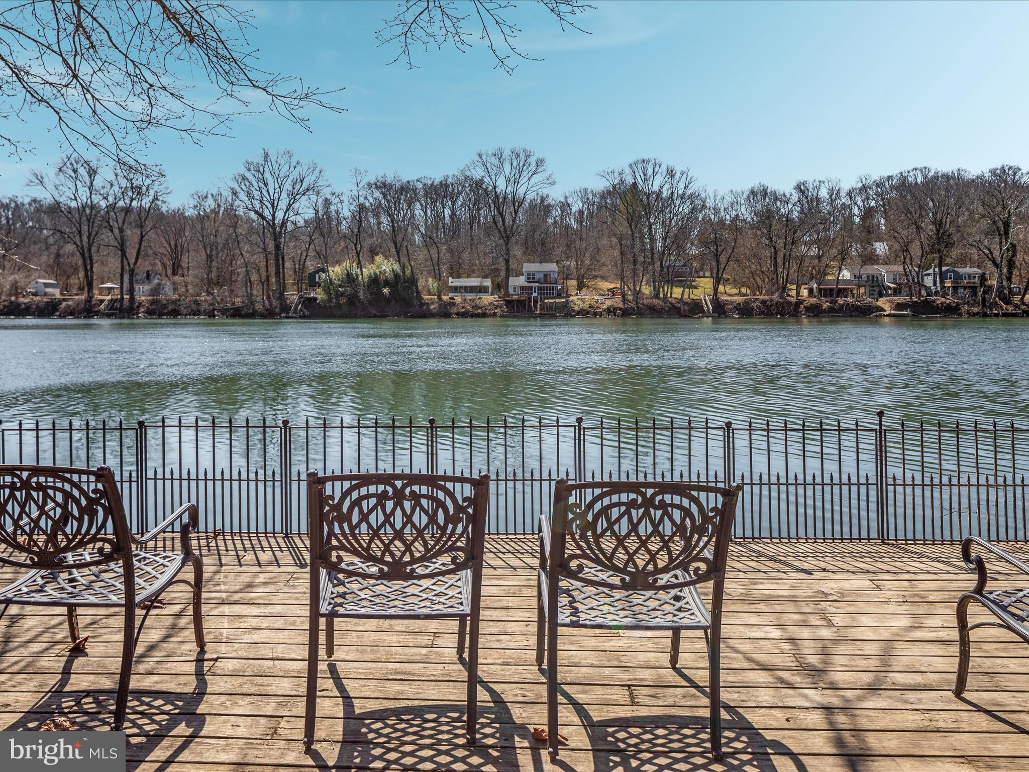 646 Old Dam Road Front Royal, VA 22630 - Photo 52 of 88 a view of a lake with table and chairs