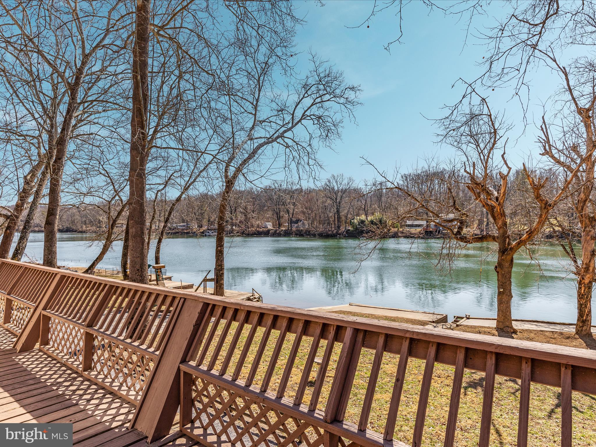 646 Old Dam Road Front Royal, VA 22630 - Photo 72 of 88 a view of a wooden deck with lake and trees in the back