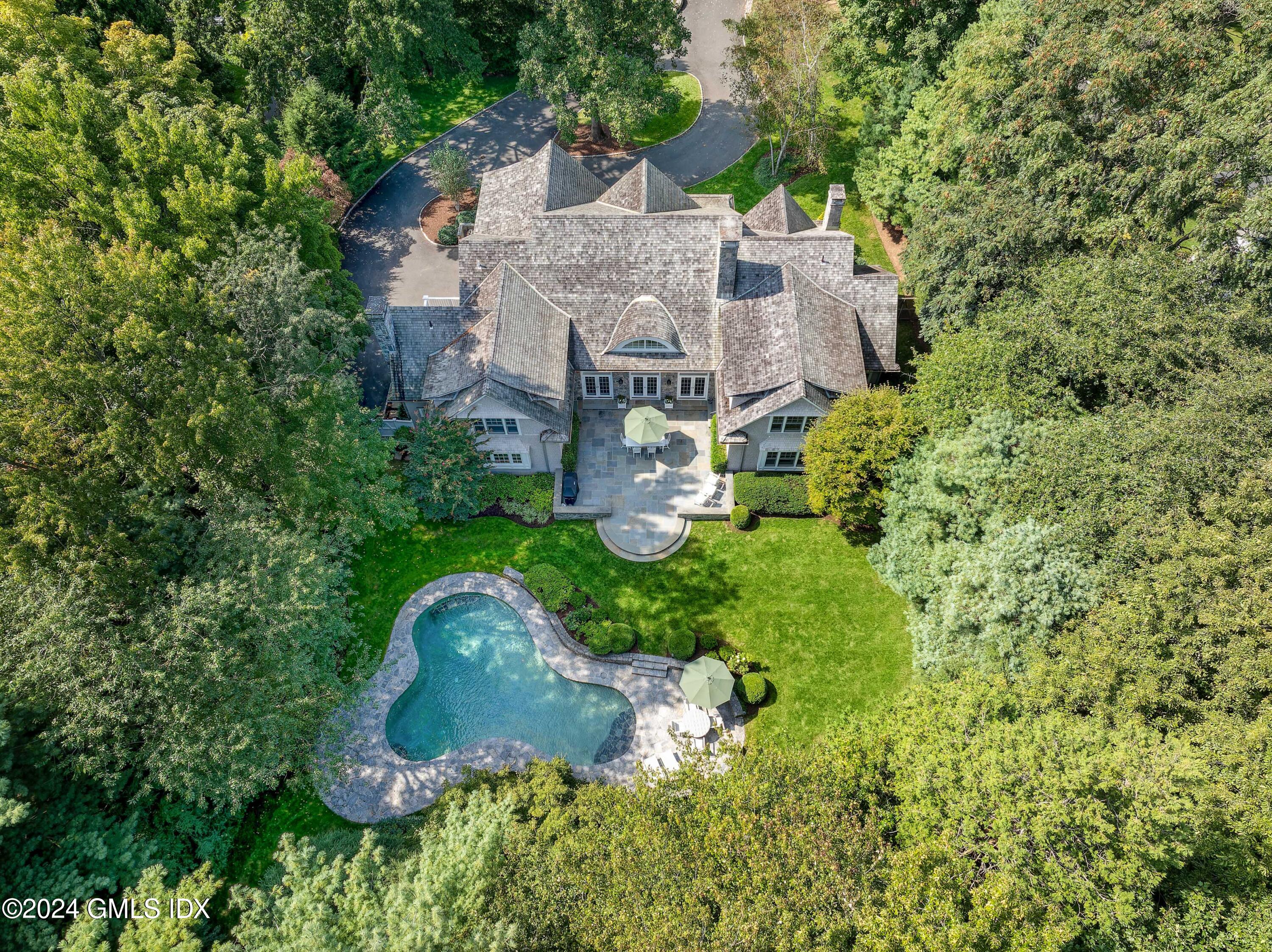 61 Indian Head Road Riverside, CT 06878 - Photo 2 of 6 an aerial view of a house with a garden and trees