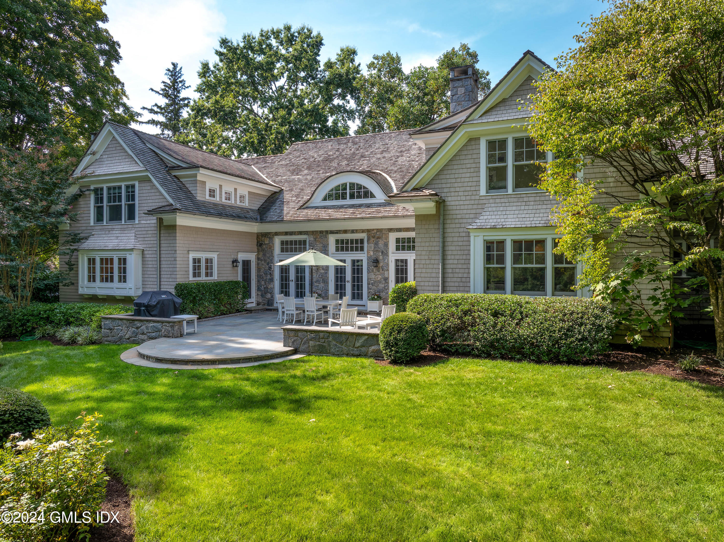 61 Indian Head Road Riverside, CT 06878 - Photo 4 of 6 a front view of a house with yard and green space