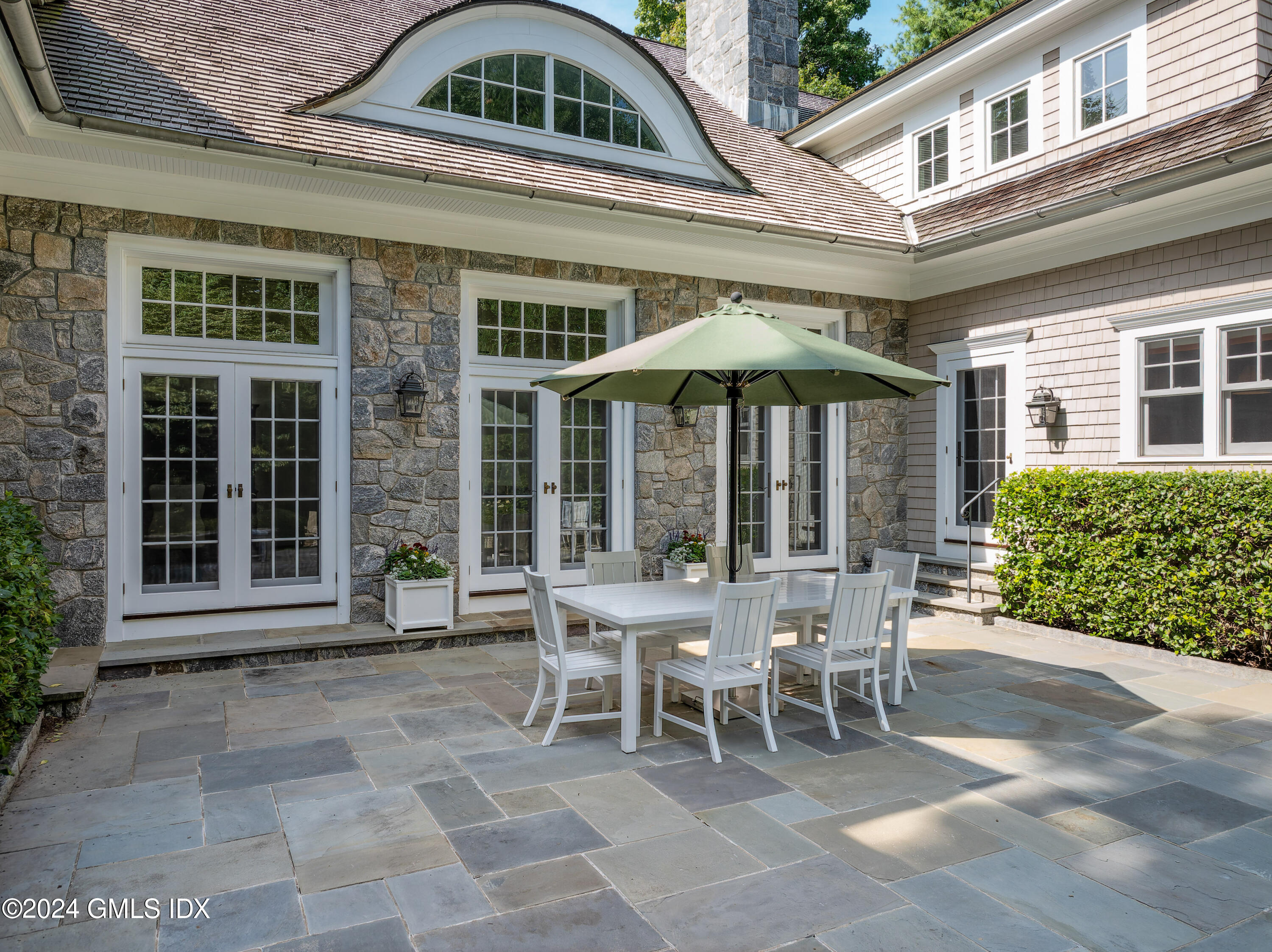 61 Indian Head Road Riverside, CT 06878 - Photo 6 of 6 a patio with a table and chairs