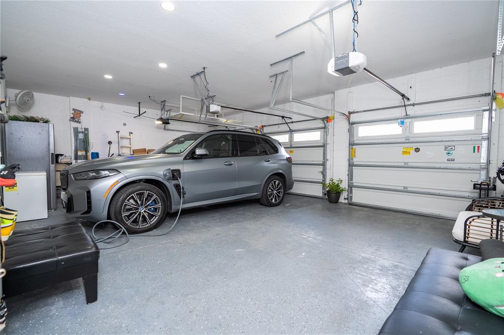 16894 Wingspread Loop Winter Garden, FL 34787 - Photo 19 of 53 a view of a garage and car parked
