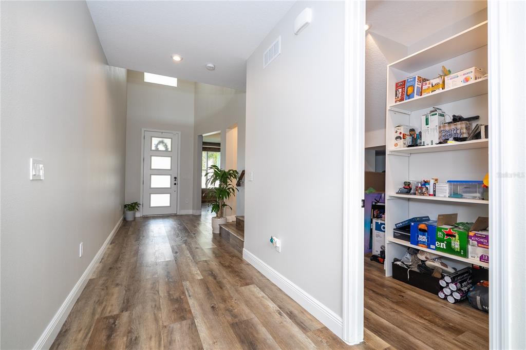 16894 Wingspread Loop Winter Garden, FL 34787 - Photo 20 of 53 a view of a hallway with wooden floor and shelves