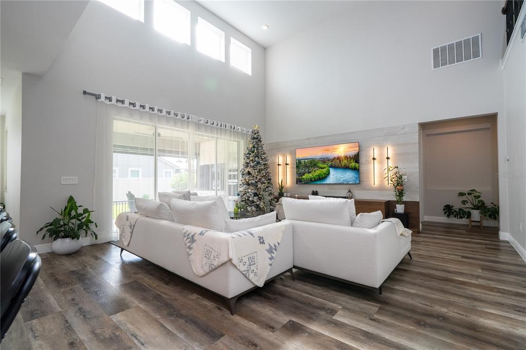 16894 Wingspread Loop Winter Garden, FL 34787 - Photo 22 of 53 a living room with furniture and a large window