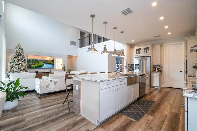 a kitchen with granite countertop cabinets and steel stainless steel appliances