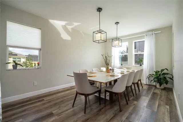 a living room with furniture and view of kitchen