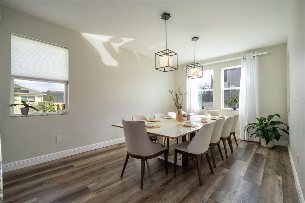 16894 Wingspread Loop Winter Garden, FL 34787 - Photo 28 of 53 a view of a dining room with furniture window and wooden floor