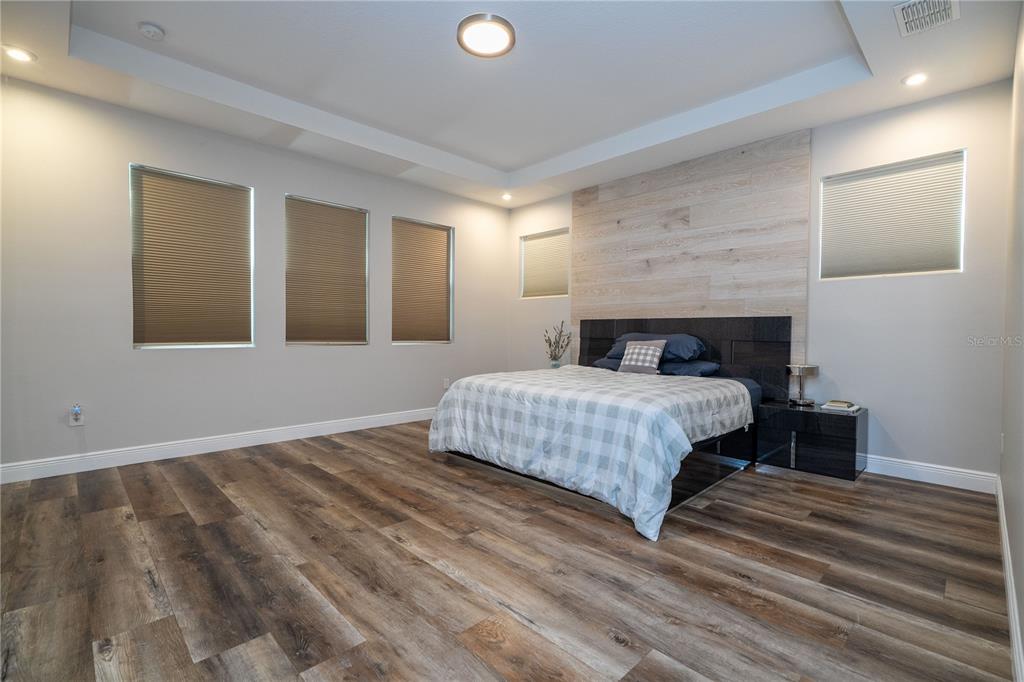 16894 Wingspread Loop Winter Garden, FL 34787 - Photo 32 of 53 a bedroom with a bed and a night stand