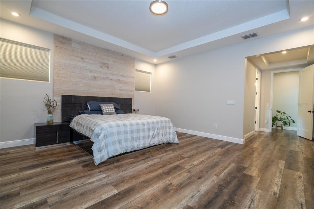 16894 Wingspread Loop Winter Garden, FL 34787 - Photo 33 of 53 a bedroom with a bed and a wooden floor