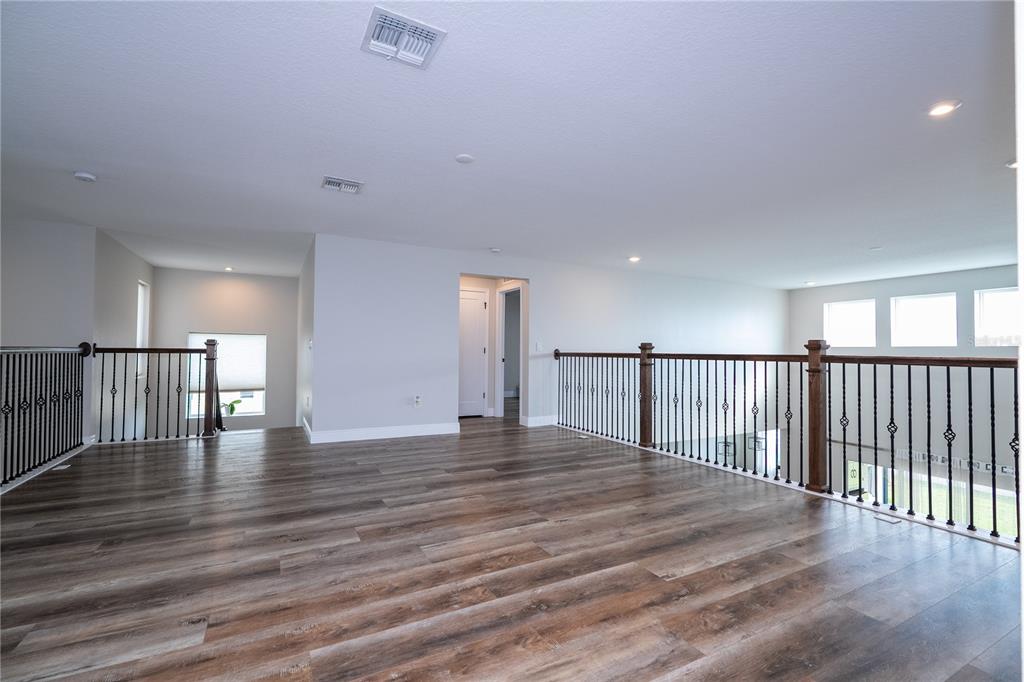 16894 Wingspread Loop Winter Garden, FL 34787 - Photo 40 of 53 a view of a hallway with wooden floor