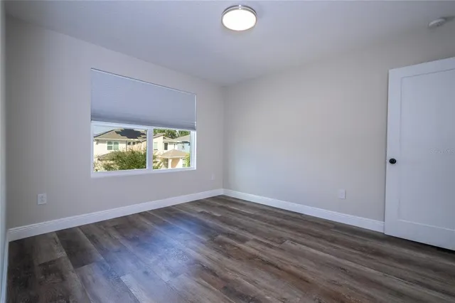 a view of an empty room and kitchen