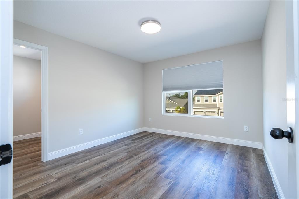 16894 Wingspread Loop Winter Garden, FL 34787 - Photo 42 of 53 an empty room with wooden floor and windows