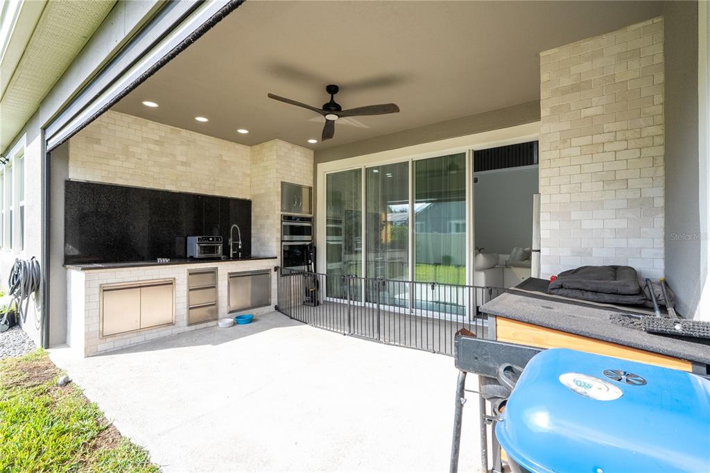 16894 Wingspread Loop Winter Garden, FL 34787 - Photo 45 of 53 a bedroom with a bed and a flat screen tv