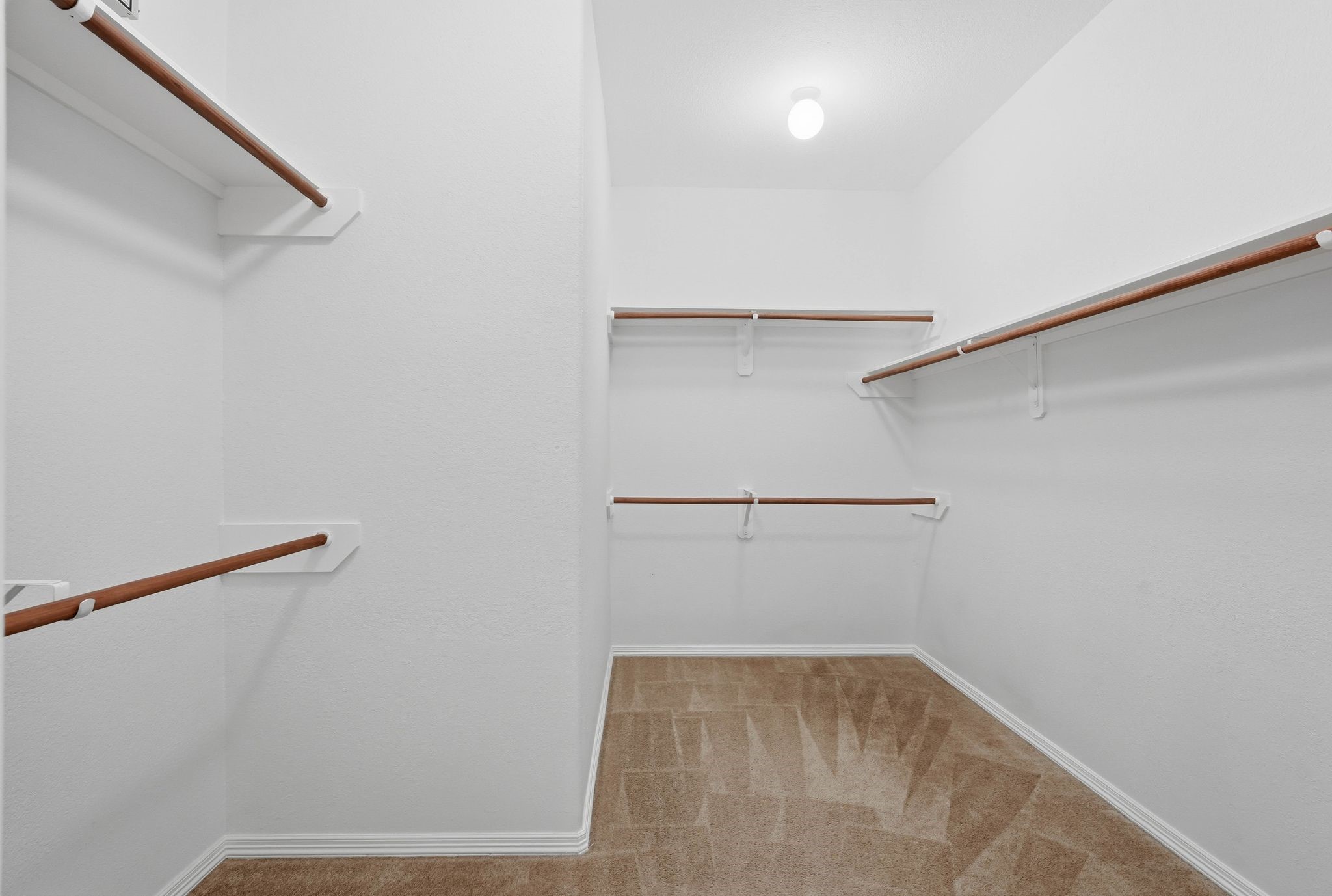 18612 Syndee Loch Court Spring, TX 77379 - Photo 17 of 27 a view of walk in closet with empty racks