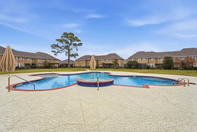 a view of an swimming pool with lounge chairs