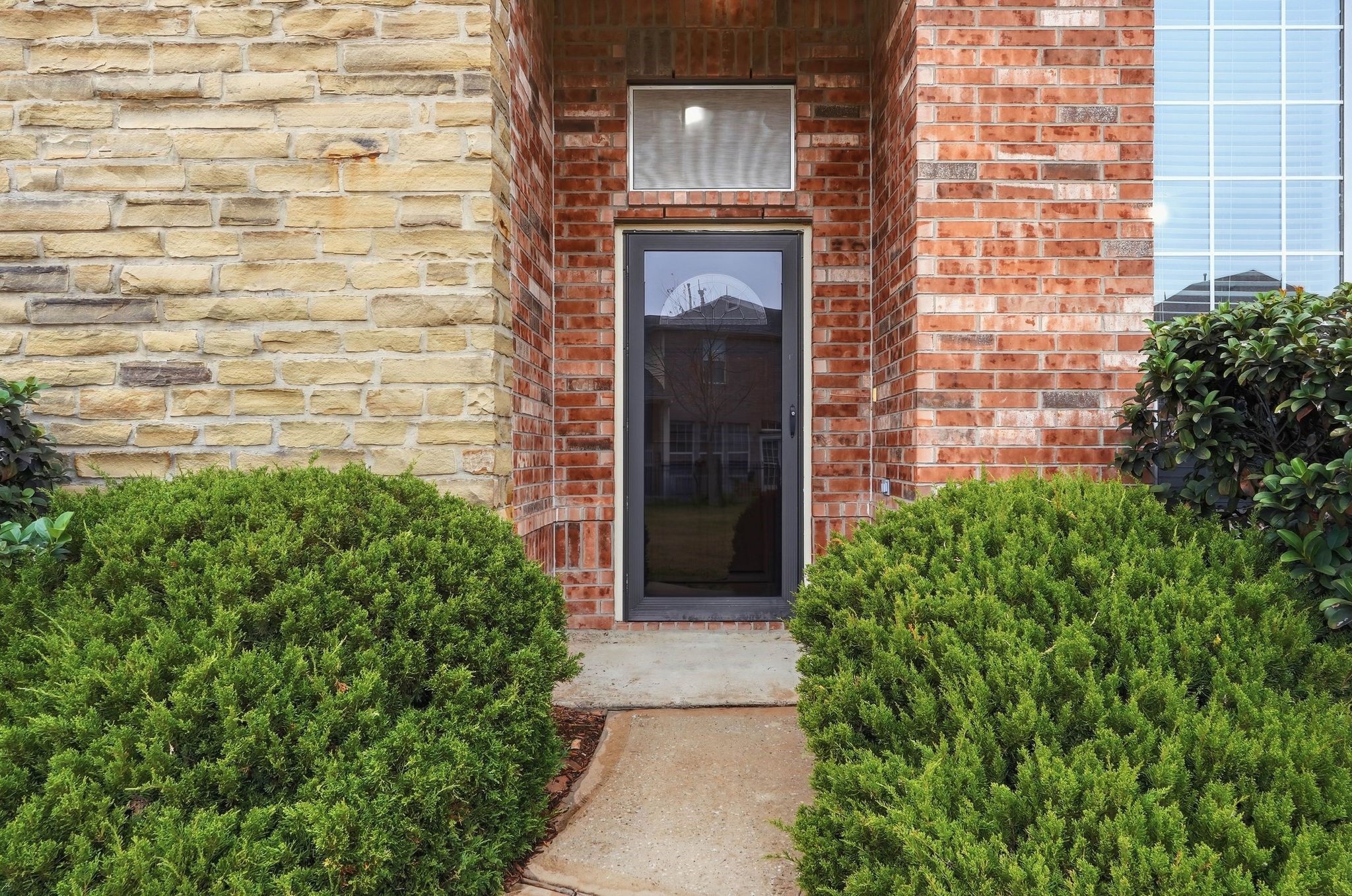 18612 Syndee Loch Court Spring, TX 77379 - Photo 5 of 27 front view of a brick house with a large window
