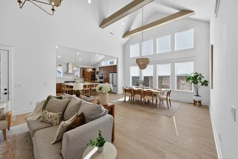 a kitchen with a stove a sink dishwasher a kitchen island with wooden cabinets and floor