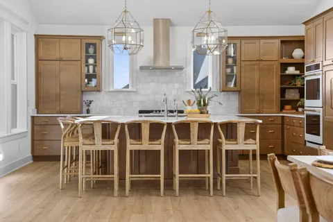 a spacious bedroom with a bed a couch and a chandelier