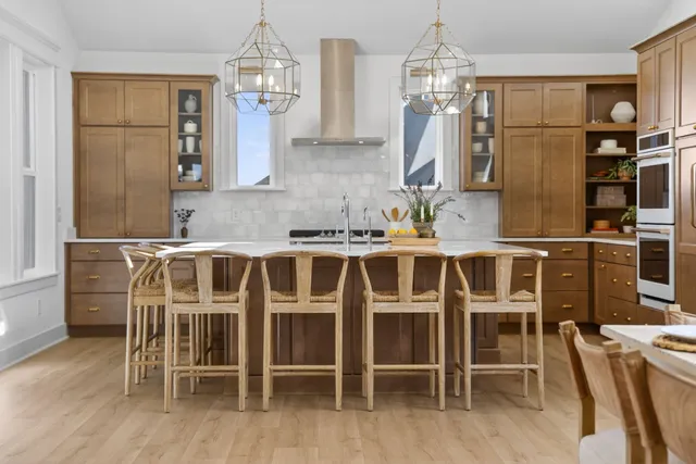 a spacious bedroom with a bed a couch and a chandelier