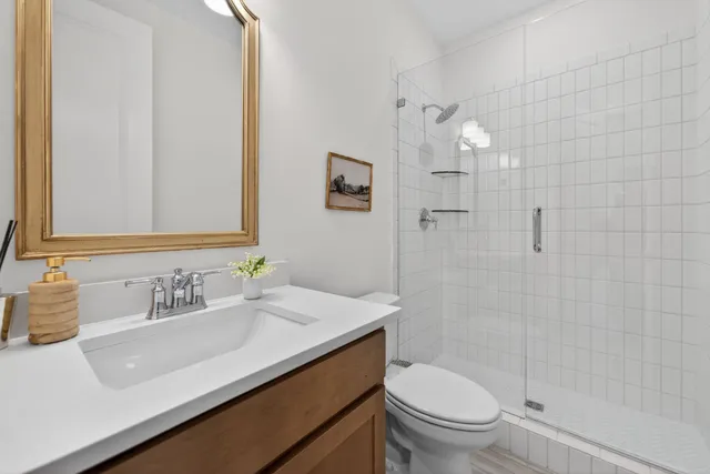 a living room with furniture a rug potted plant and a large window