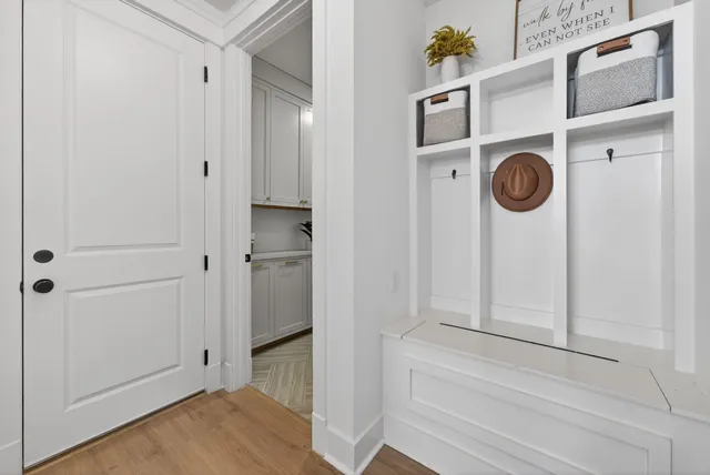 a dining hall with couches a dining table and chairs with wooden floor