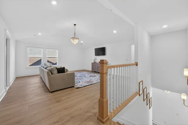 a roof deck with table and chairs and wooden floor
