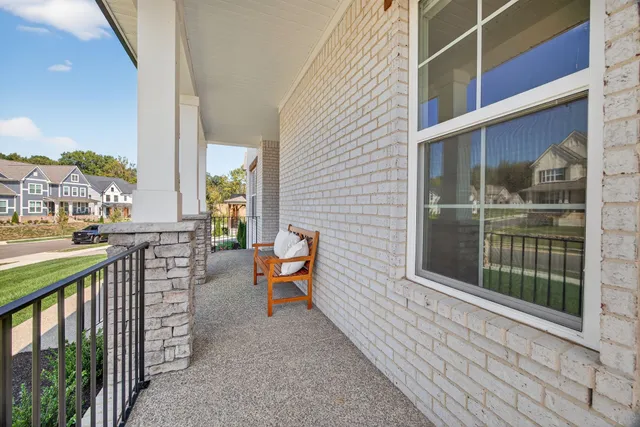 a view of a dining room with furniture a fireplace and wooden floor