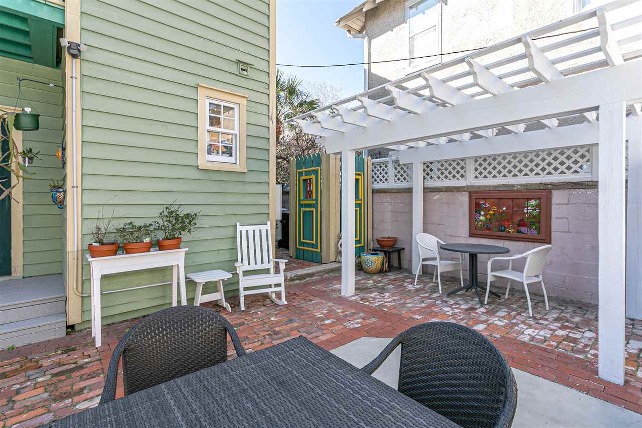 63 Marine Street St. Augustine, FL 32084 - Photo 12 of 42 a view of a house with a chairs in patio